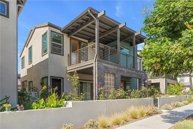 a view of a house with a small yard and potted plants
