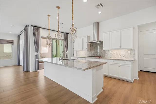 a large kitchen with granite countertop a sink a counter space and stainless steel appliances
