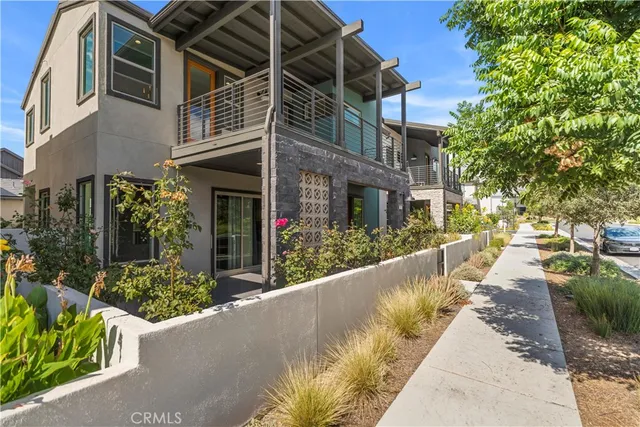 a view of a house with potted plants