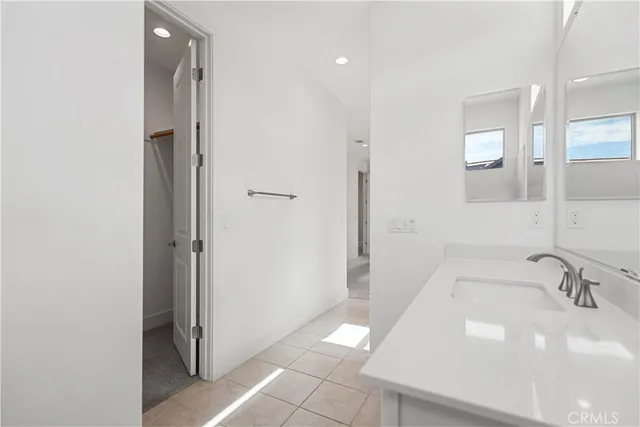 a view of empty room with wooden floor and chandelier