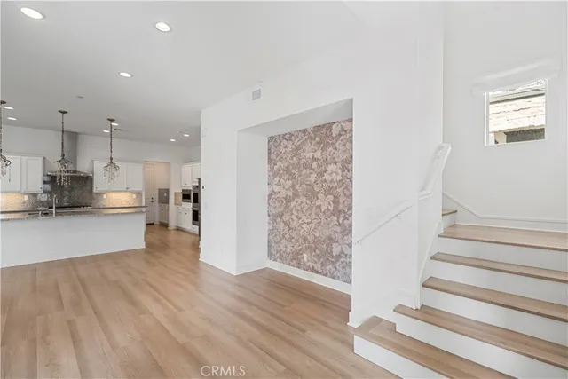 a view of kitchen with cabinets and wooden floor