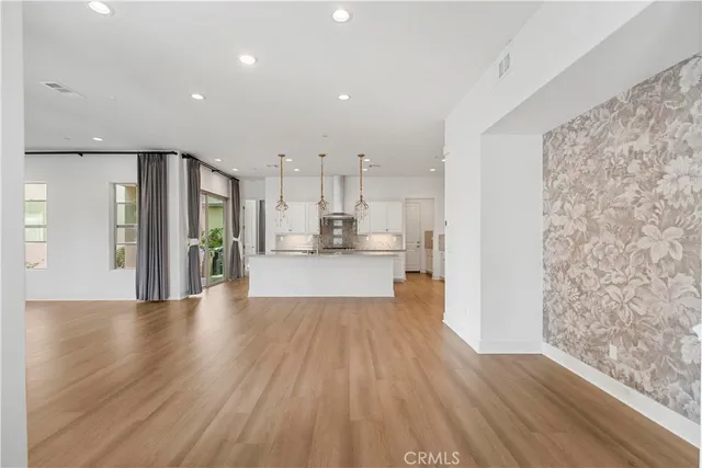 a view of a kitchen with furniture and wooden floor