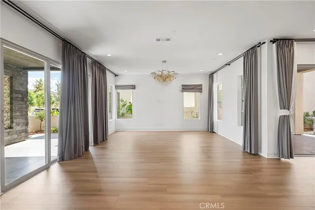 a view of livingroom with hardwood floor and front door