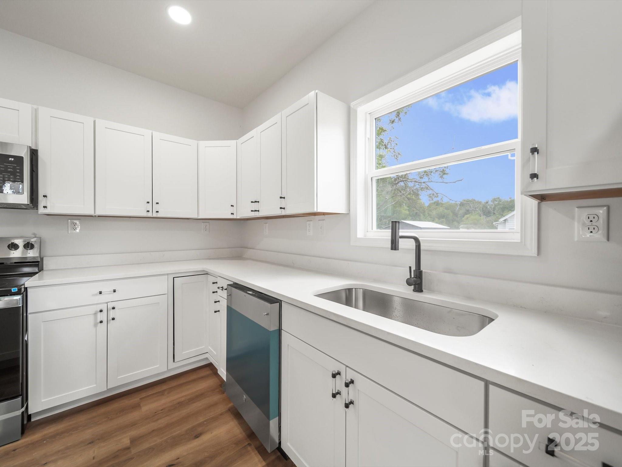 334 South Pink Street Cherryville, NC 28021 - Photo 11 of 25 a kitchen with sink cabinets and wooden floor