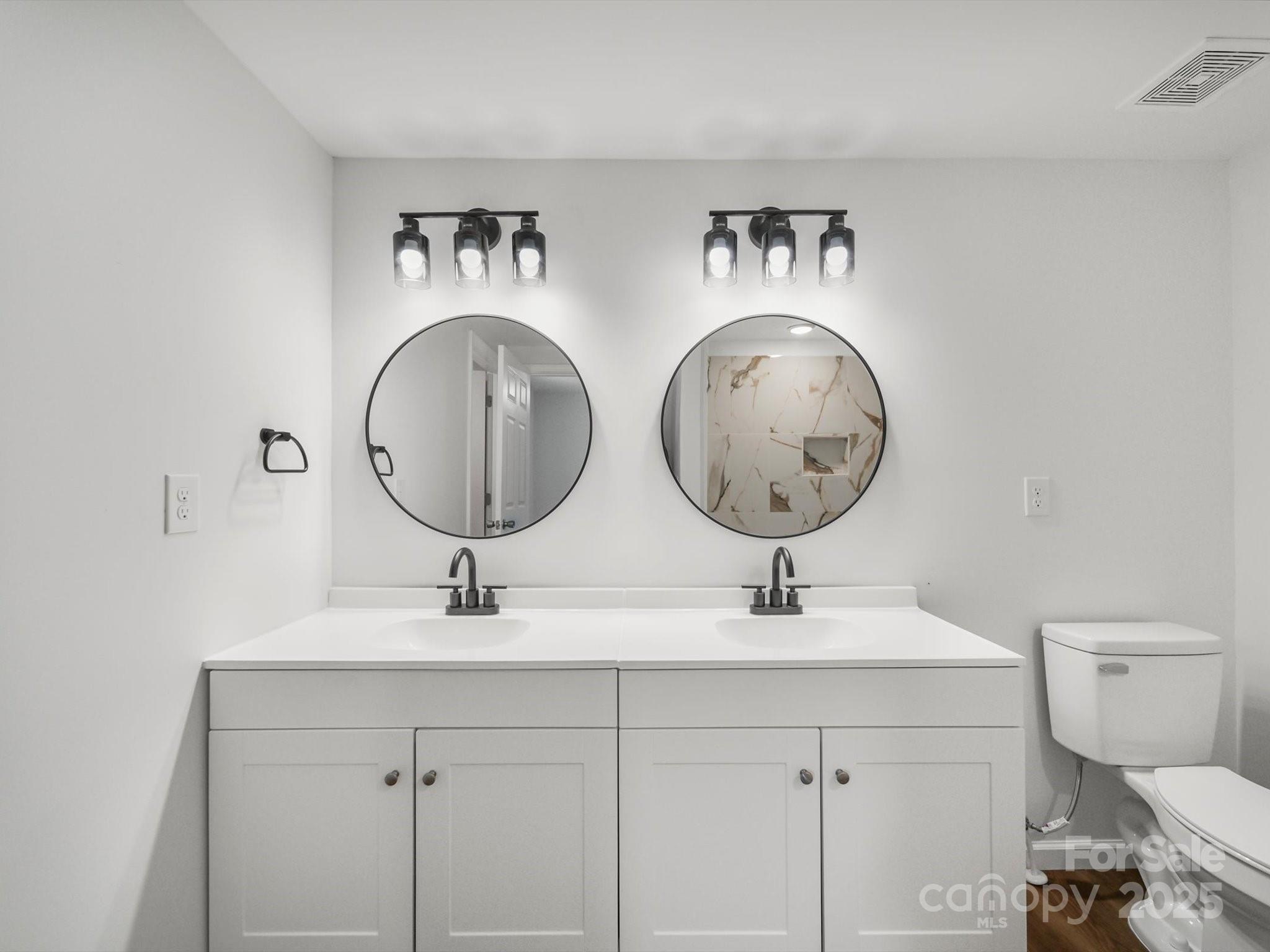334 South Pink Street Cherryville, NC 28021 - Photo 15 of 25 a bathroom with a toilet and a mirror