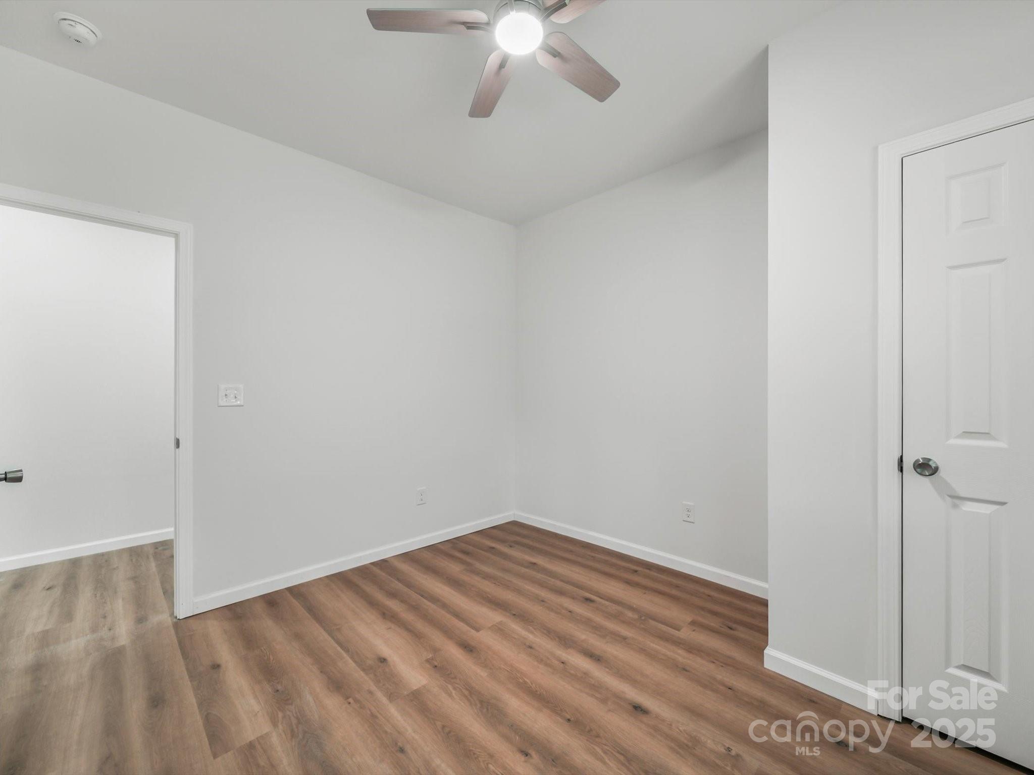 334 South Pink Street Cherryville, NC 28021 - Photo 18 of 25 a view of room with wooden floor and ceiling fan
