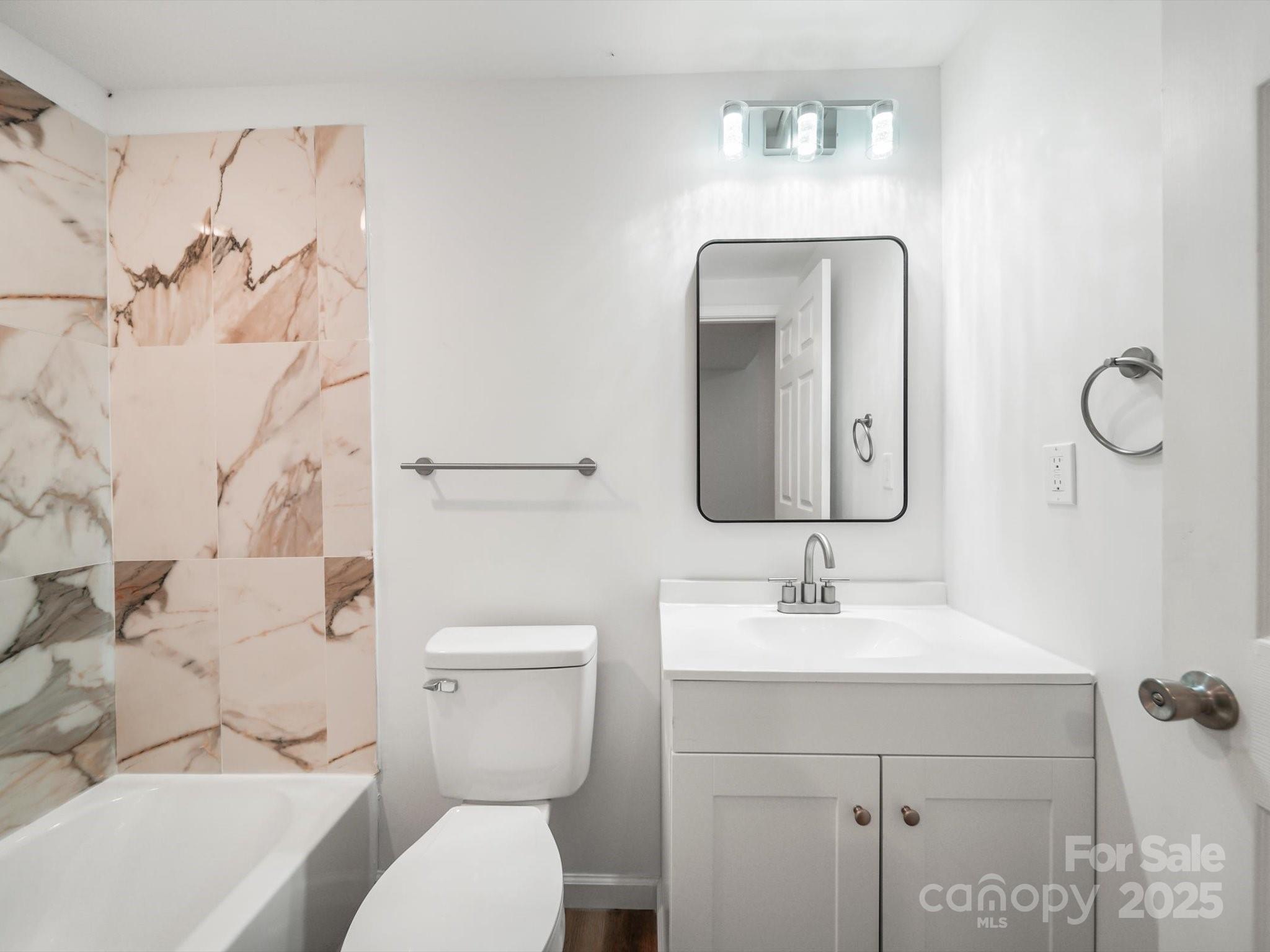 334 South Pink Street Cherryville, NC 28021 - Photo 19 of 25 a bathroom with a toilet sink and mirror