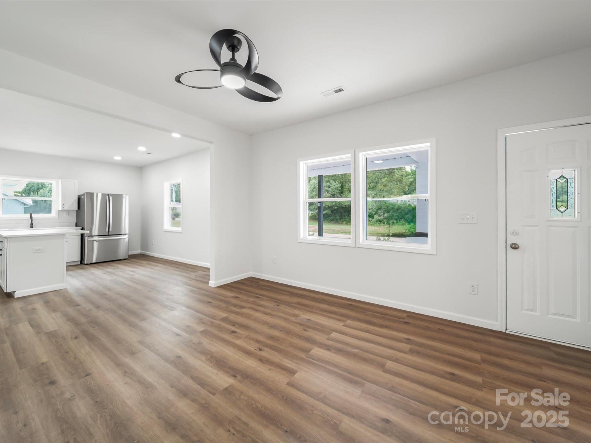 334 South Pink Street Cherryville, NC 28021 - Photo 3 of 25 a view of empty room with wooden floor and windows