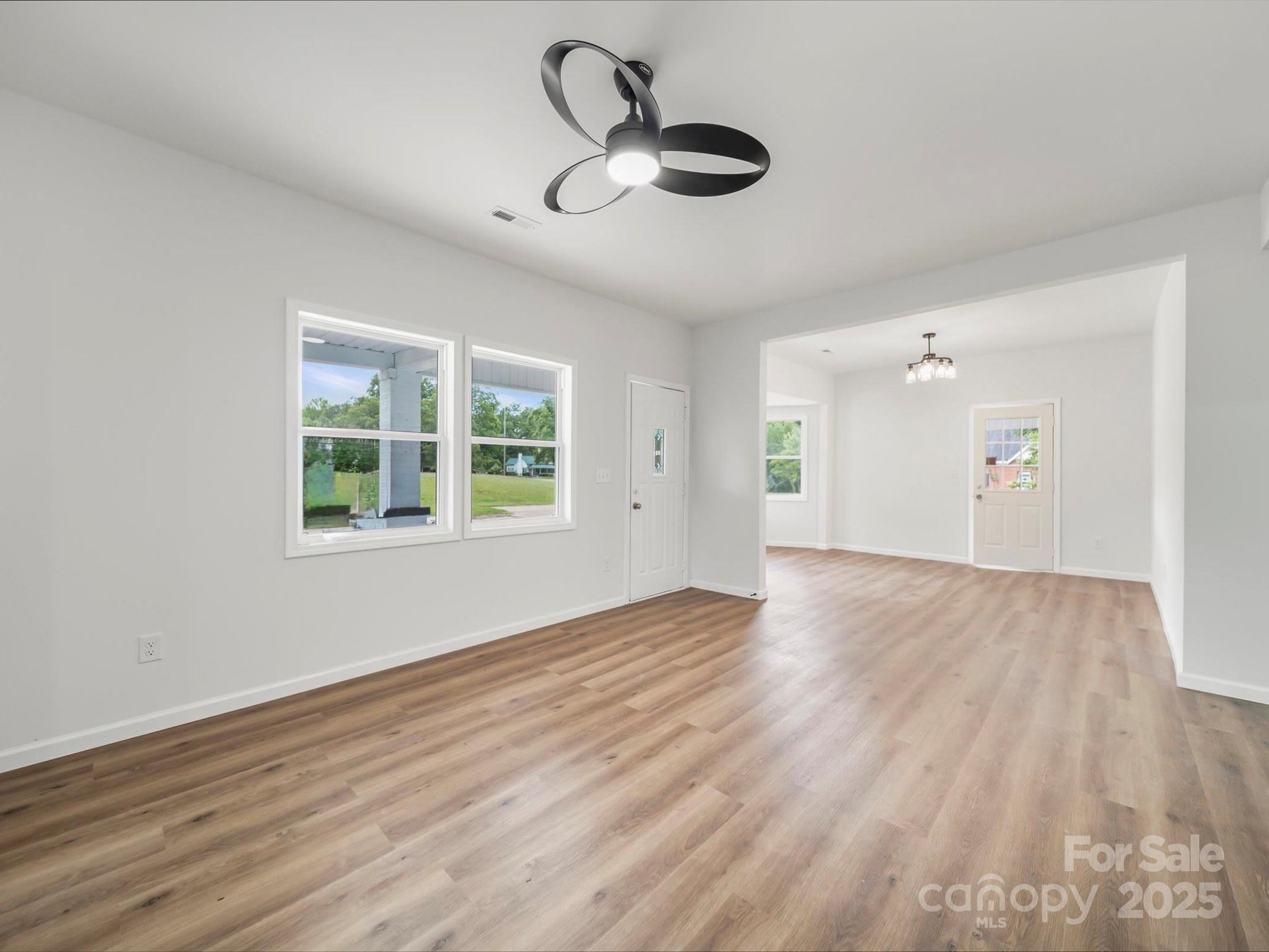 334 South Pink Street Cherryville, NC 28021 - Photo 4 of 25 a view of empty room with wooden floor and windows