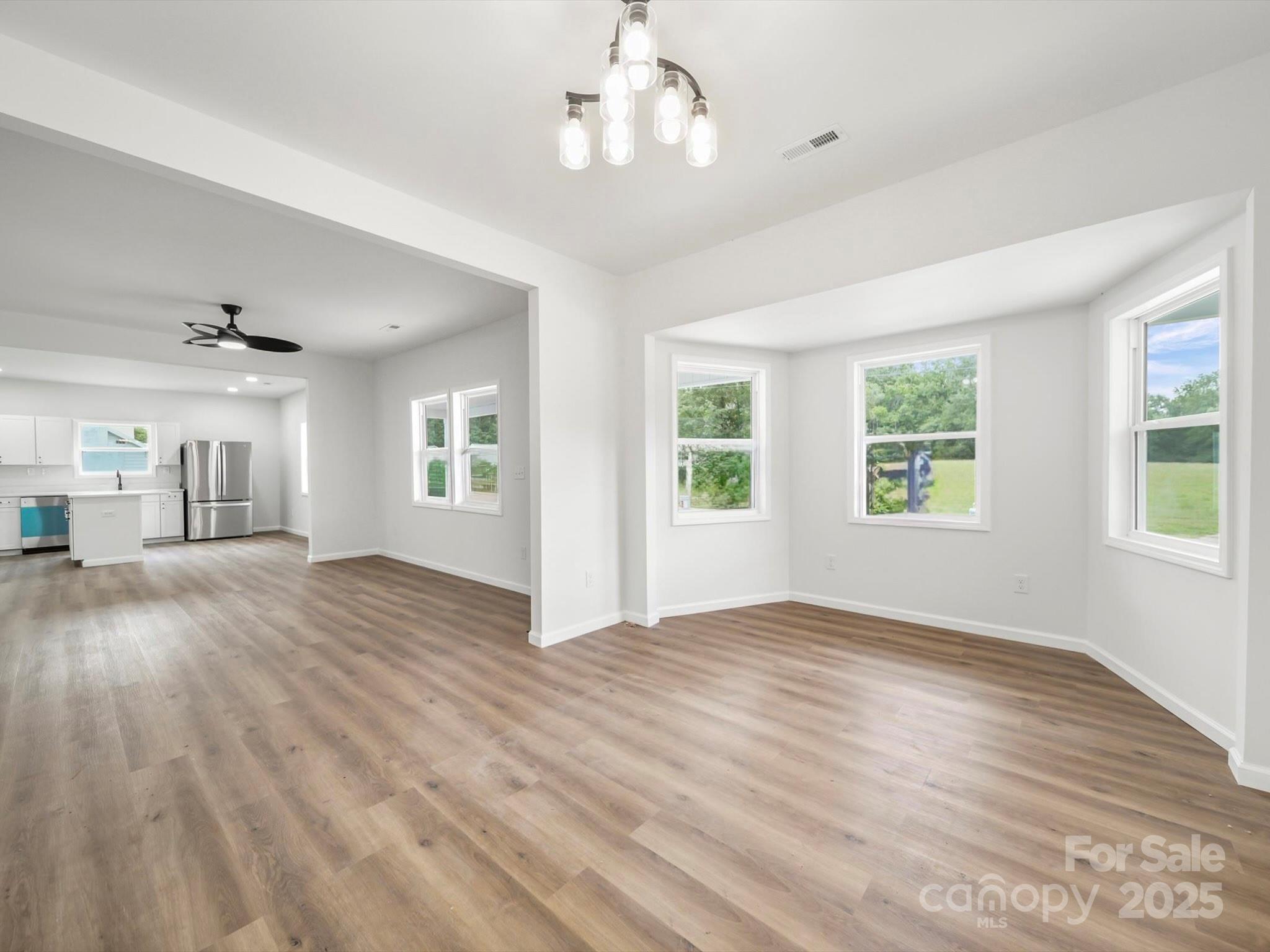 334 South Pink Street Cherryville, NC 28021 - Photo 5 of 25 a view of empty room with wooden floor and fan