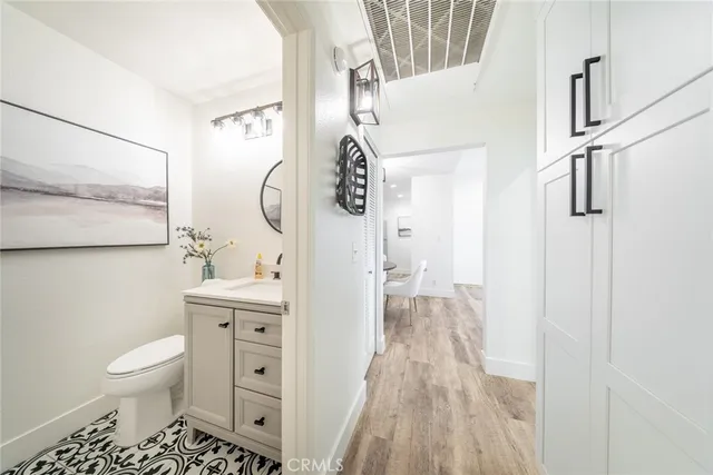 a bathroom with a toilet a sink and a mirror