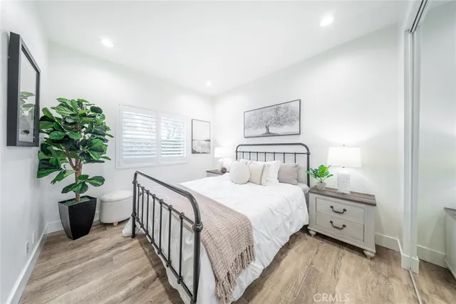 a bedroom with a bed and a potted plant