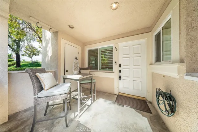 a living room with furniture a window and a table