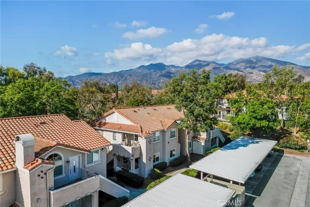 an aerial view of a house with a yard and balcony