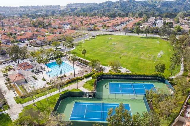 an aerial view of residential houses with outdoor space and swimming pool