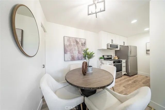 a dining room with furniture and a mirror