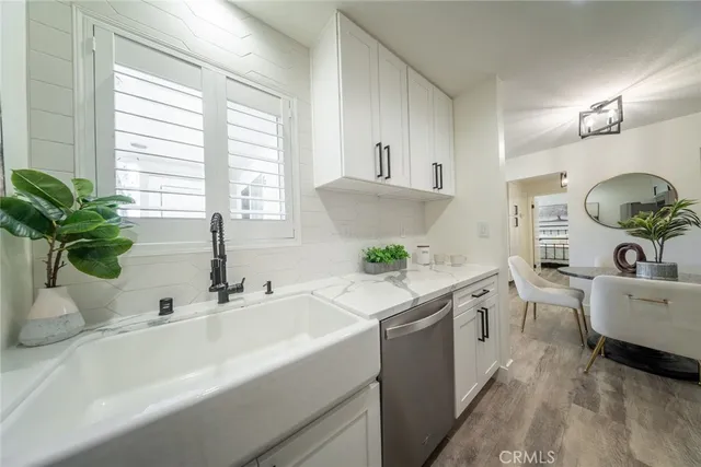a kitchen with a sink cabinets and window