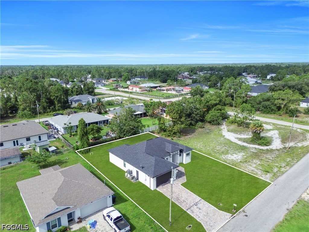 3509 38th Street Southwest Lehigh Acres, FL 33976 - Photo 43 of 47 an aerial view of residential houses with outdoor space and lake view in back