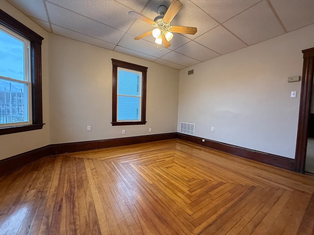 38 Ames Street, Unit 2 Worcester, MA 01610 - Photo 1 of 9 a view of empty room with wooden floor and fan