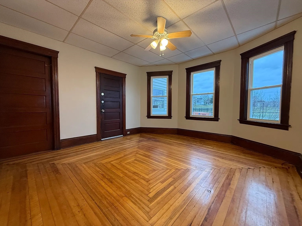 38 Ames Street, Unit 2 Worcester, MA 01610 - Photo 2 of 9 a view of an empty room with window and wooden floor