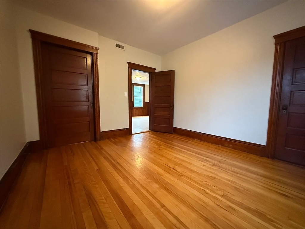 38 Ames Street, Unit 2 Worcester, MA 01610 - Photo 6 of 9 a view of an empty room with wooden floor and closet