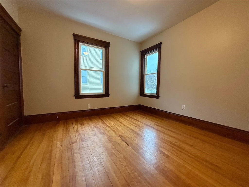 38 Ames Street, Unit 2 Worcester, MA 01610 - Photo 7 of 9 a view of an empty room with wooden floor and a window