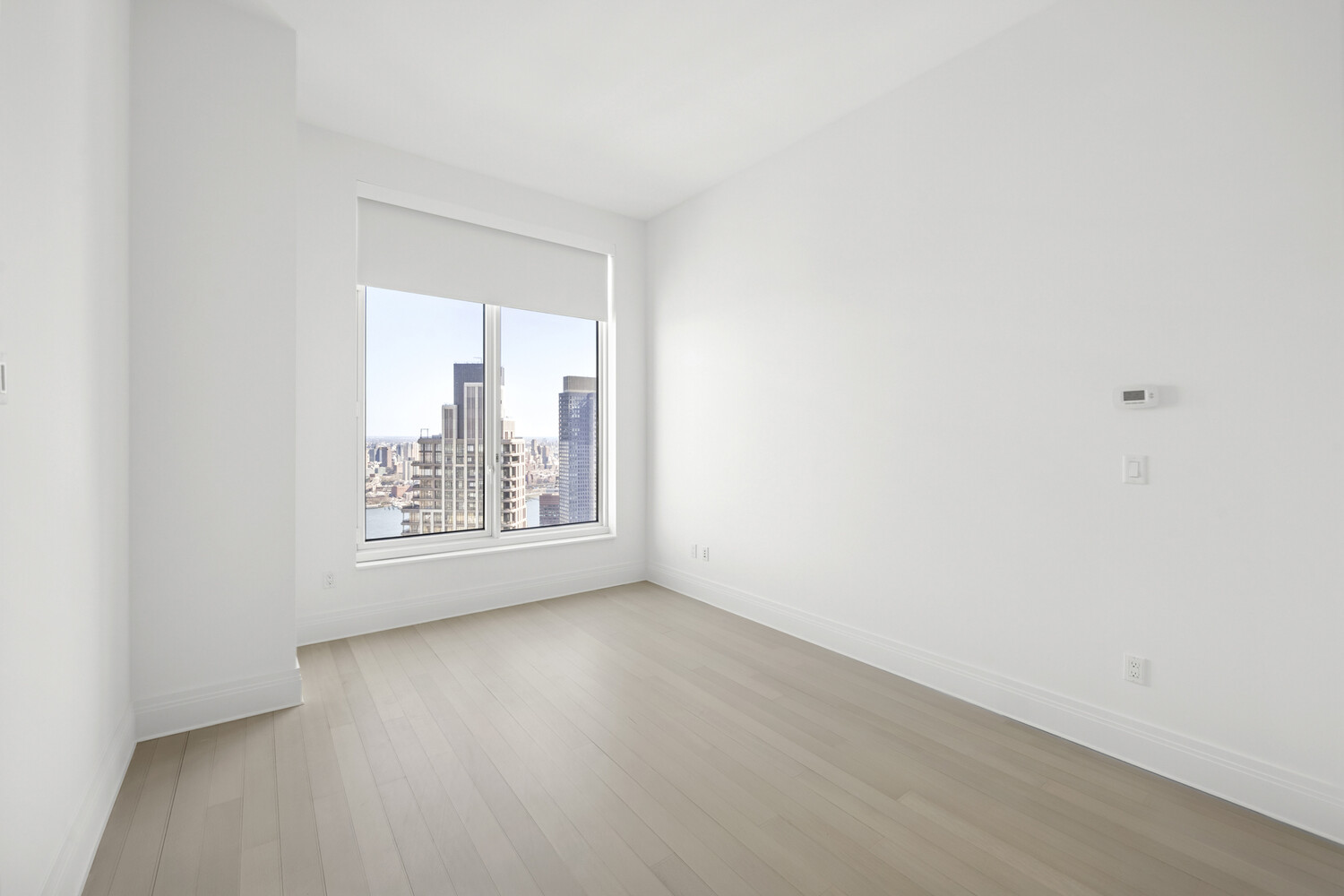 30 Park Place, Unit 61C Manhattan, NY 10007 - Photo 11 of 14 a view of an empty room with wooden floor and a window