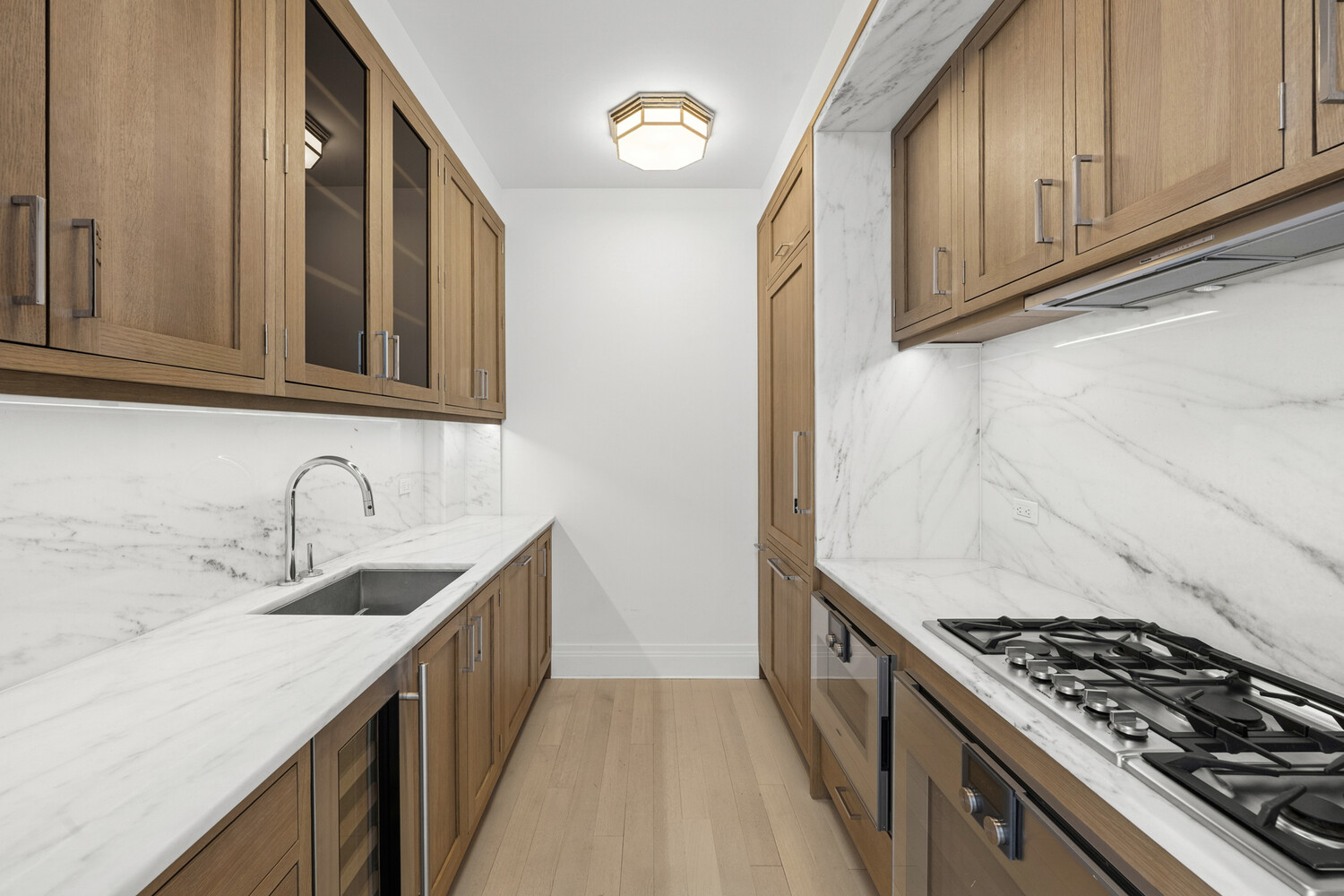 30 Park Place, Unit 61C Manhattan, NY 10007 - Photo 7 of 14 a kitchen with granite countertop a sink stove and cabinets