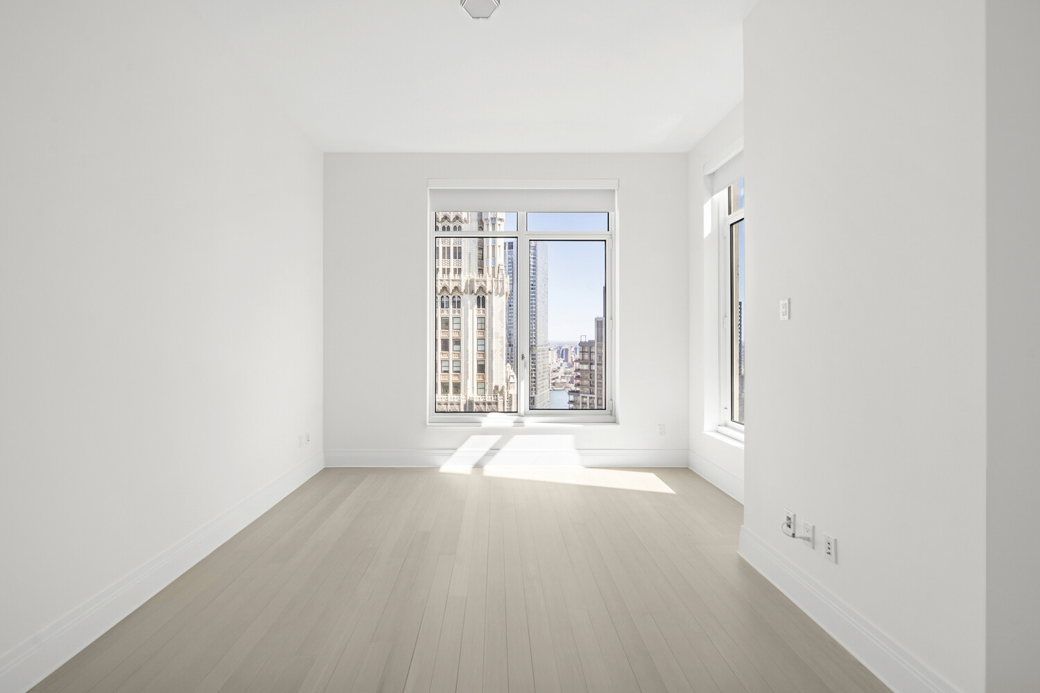 30 Park Place, Unit 61C Manhattan, NY 10007 - Photo 9 of 14 an empty room with windows