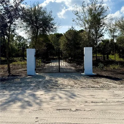 a view of a road with large trees