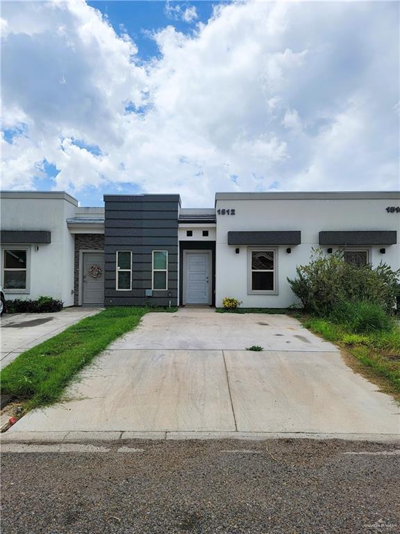 a front view of a house with a yard and a garage