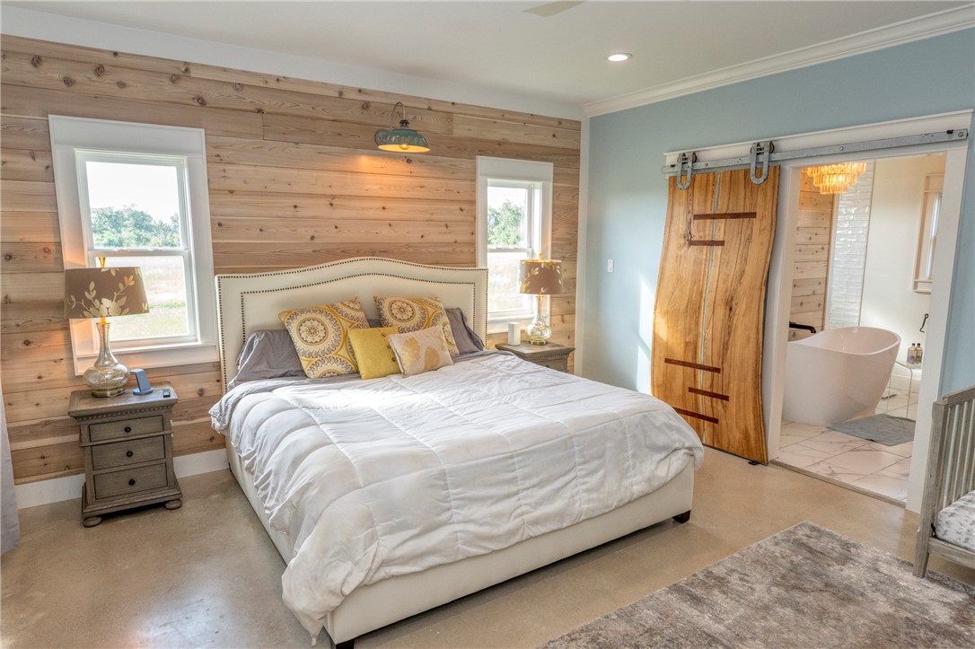 7105 Watermelon Road Somerville, TX 77879 - Photo 20 of 40 a bedroom with a bed and wooden floor