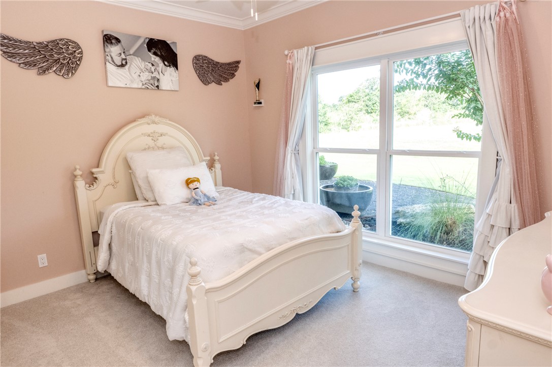 7105 Watermelon Road Somerville, TX 77879 - Photo 24 of 40 a bedroom with a bed and window