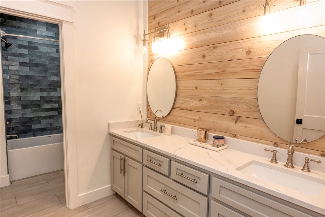 7105 Watermelon Road Somerville, TX 77879 - Photo 27 of 40 a bathroom with a double vanity sink and a mirror