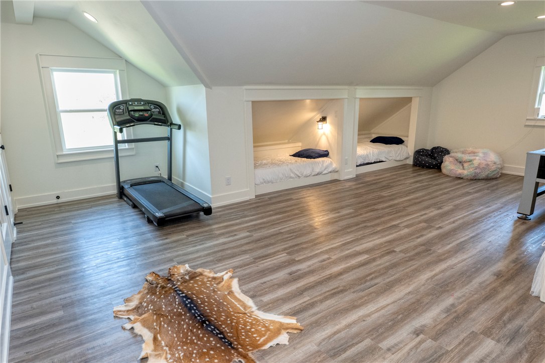 7105 Watermelon Road Somerville, TX 77879 - Photo 31 of 40 a bedroom with wooden floor and gym equipment