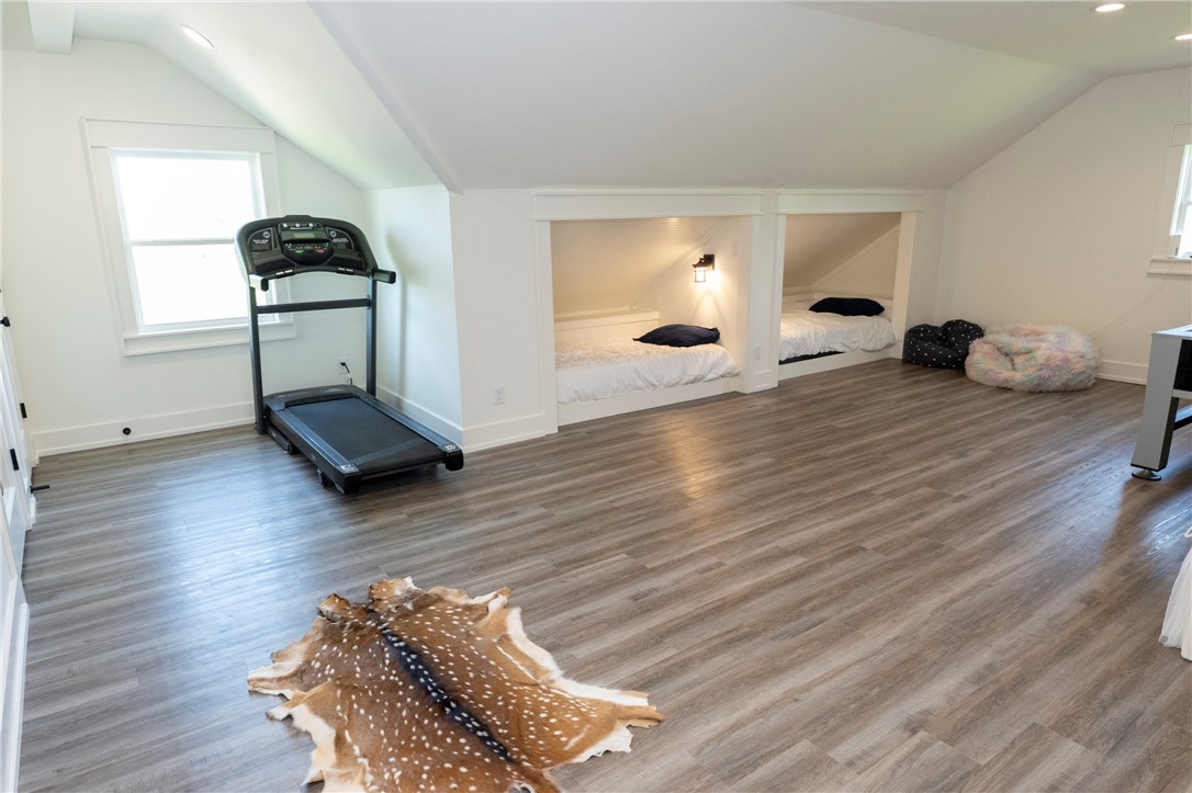 7105 Watermelon Road Somerville, TX 77879 - Photo 33 of 40 a bedroom with wooden floor and gym equipment