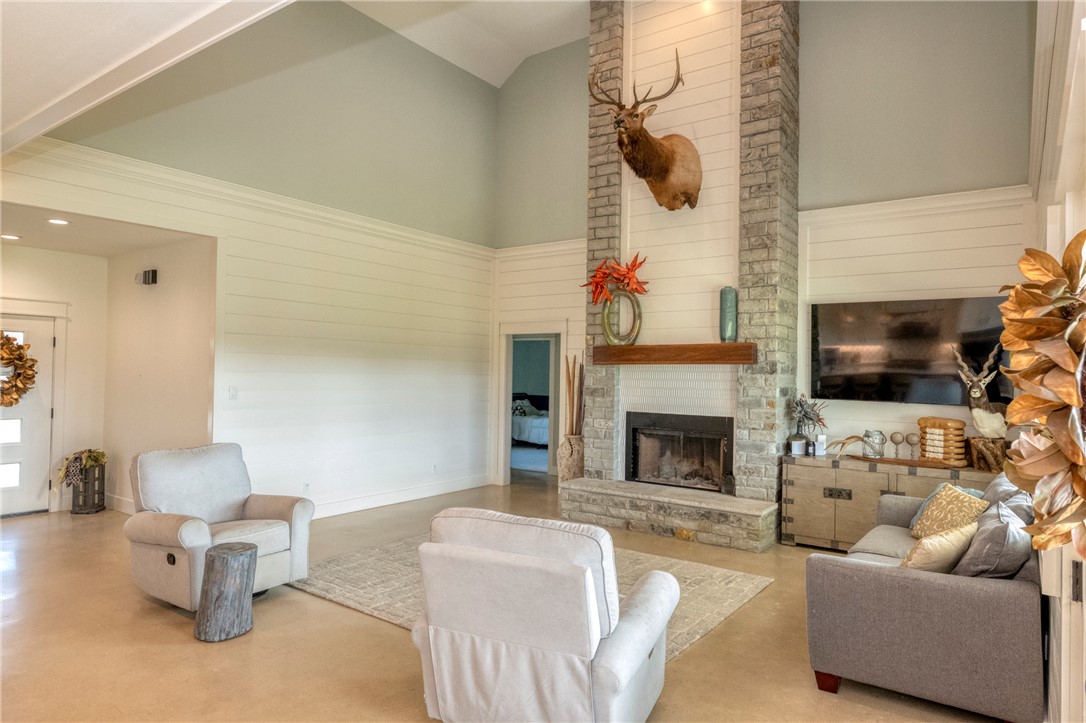 7105 Watermelon Road Somerville, TX 77879 - Photo 8 of 40 a living room with furniture a flat screen tv and a fireplace