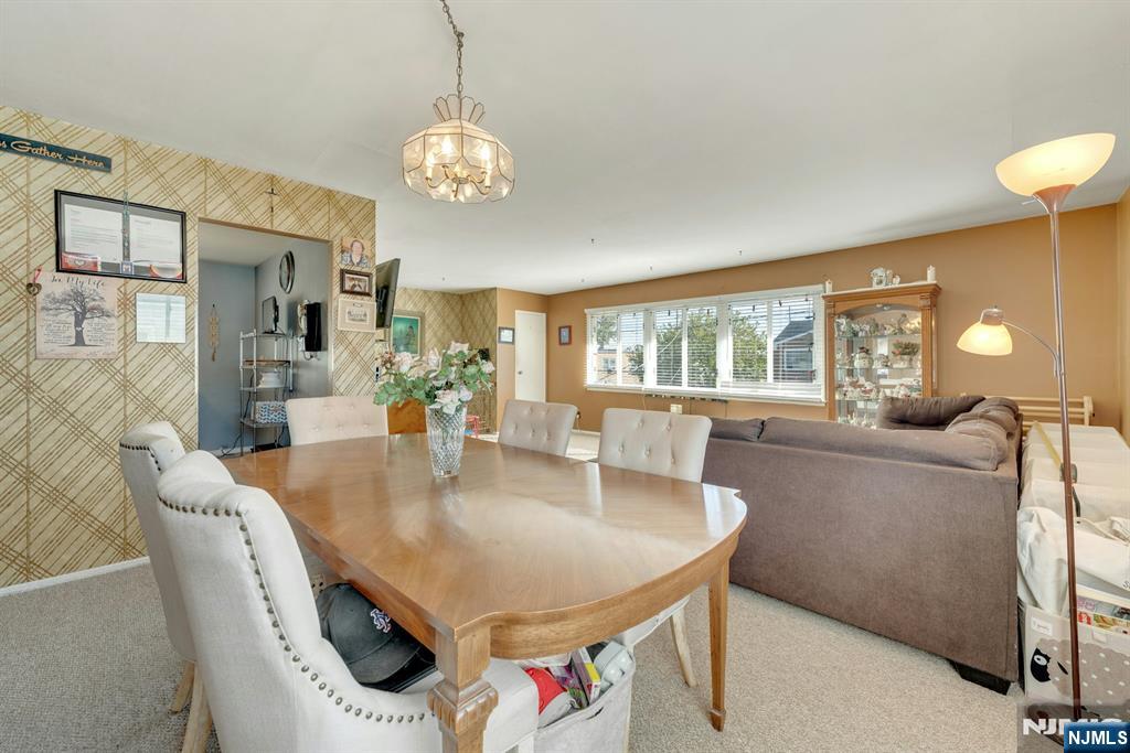 18 Ferncliff Road Jersey City, NJ 07305 - Photo 25 of 33 a dining room with furniture a chandelier and wooden floor
