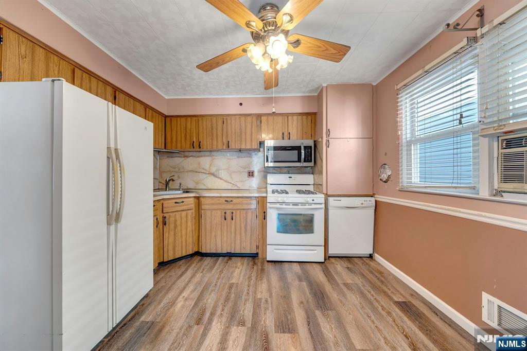 18 Ferncliff Road Jersey City, NJ 07305 - Photo 8 of 33 a kitchen with a sink cabinets stainless steel appliances and a window