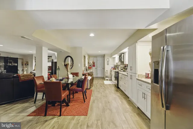 a view of a dining room with furniture a rug and wooden floor