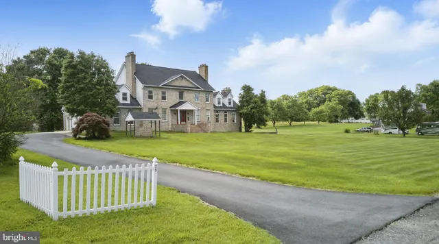 a front view of a house with a yard table and chairs