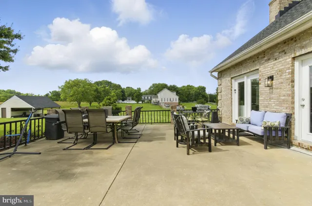 a view of a house with pool and a yard