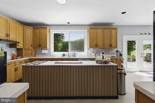 a kitchen with a window a sink and a counter top space
