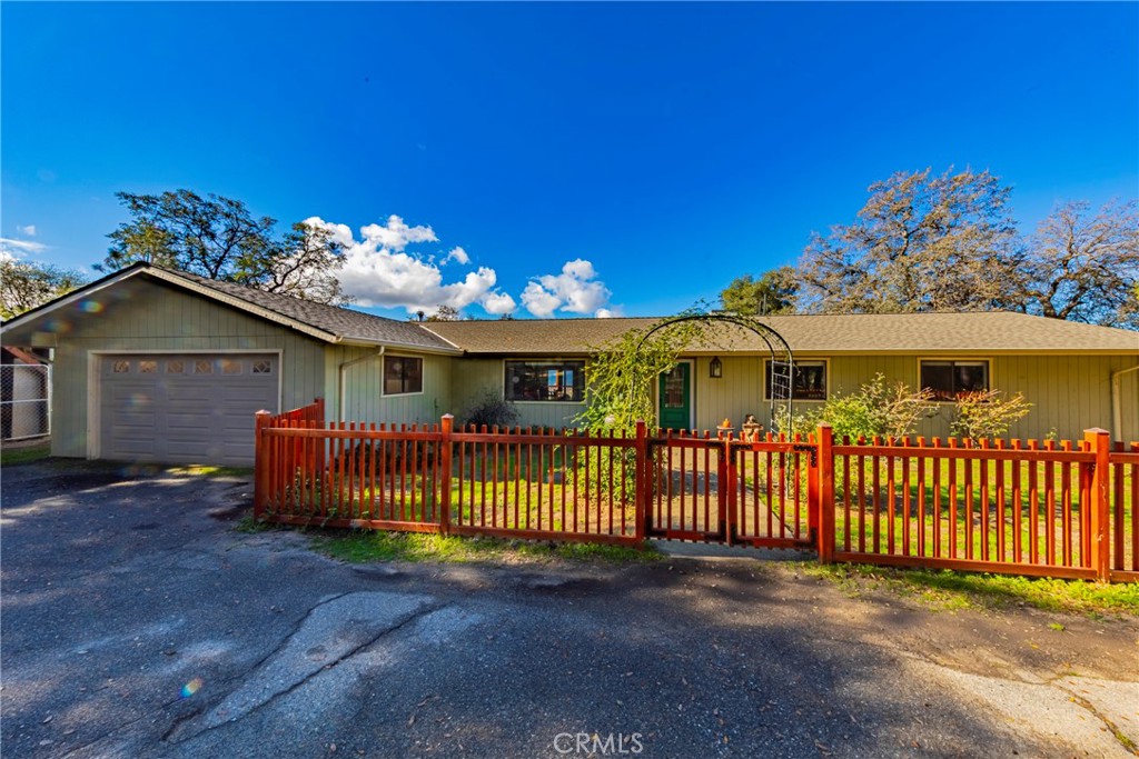 40733 Big Oak Flat Road South Oakhurst, CA 93644 - Photo 1 of 1 a view of a house with a wooden fence
