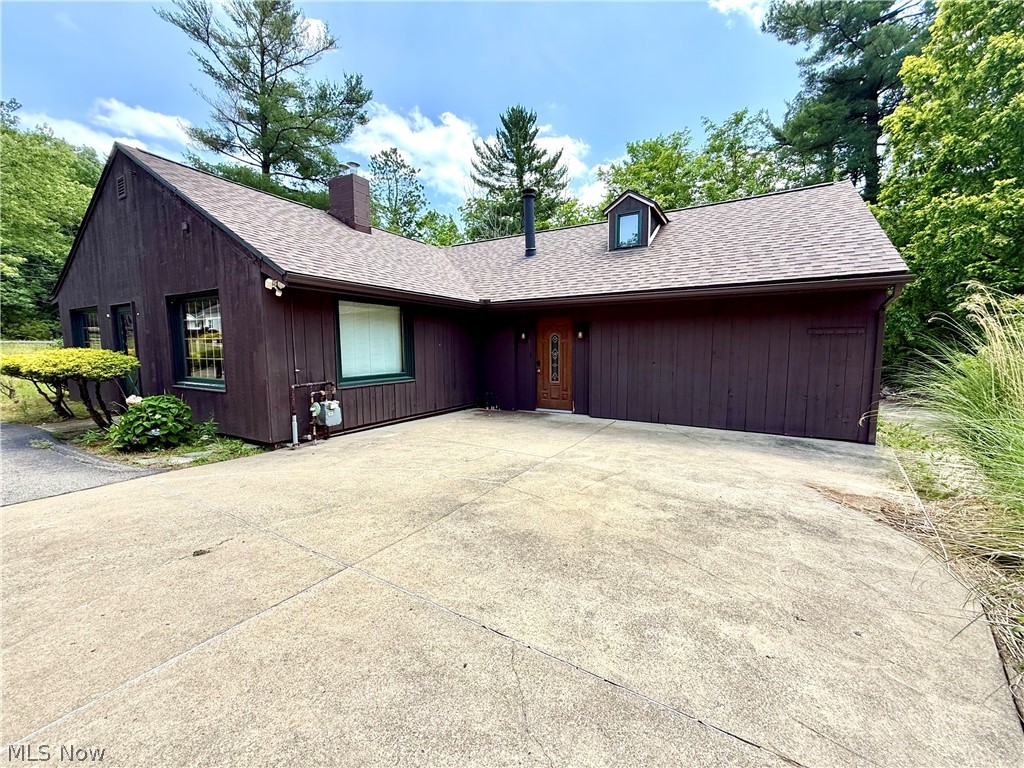 12590 Rockhaven Road Chesterland, OH 44026 - Photo 4 of 25 Brown exterior with a dormer window and a pitched roof