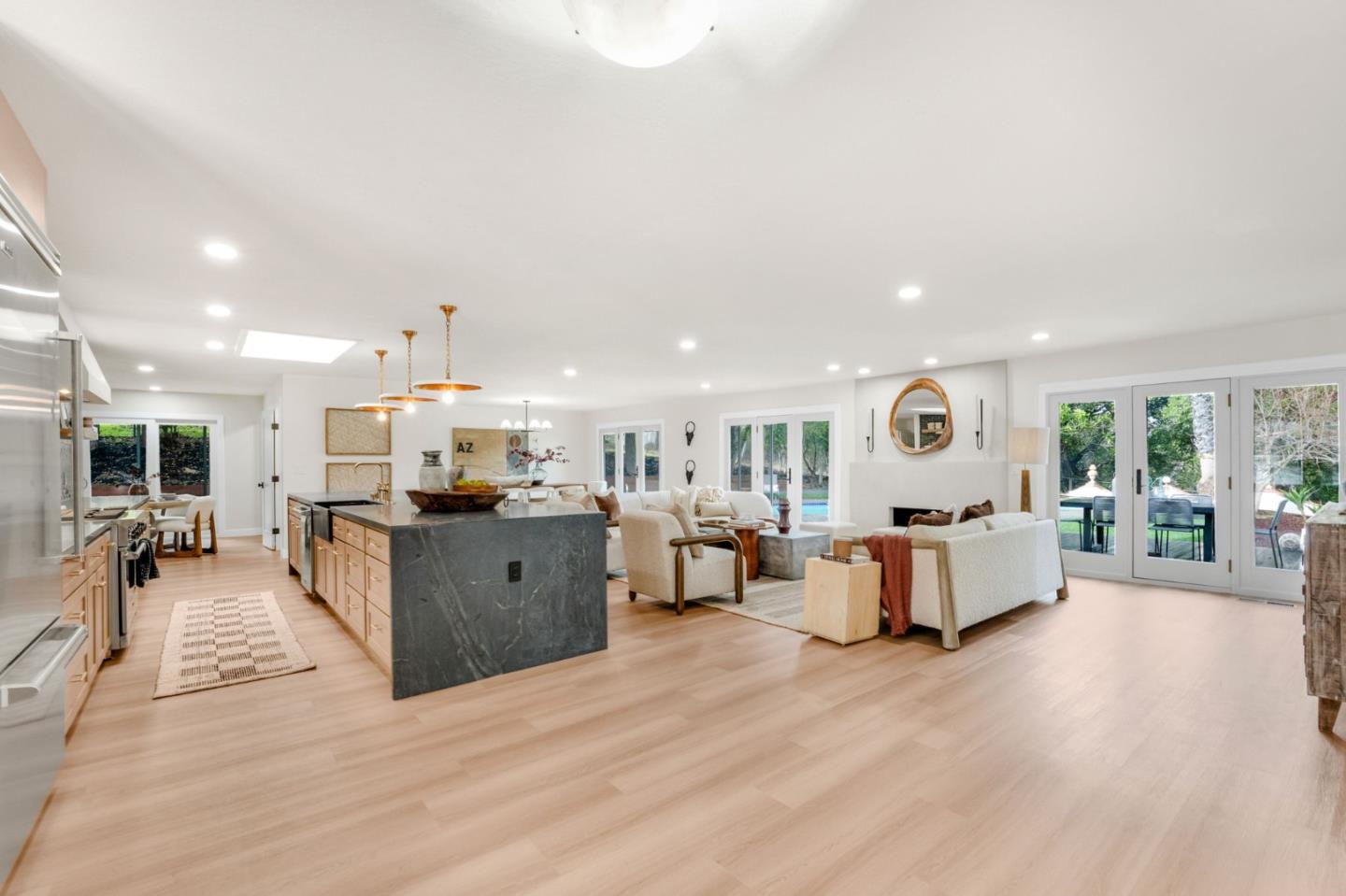 26645 Altamont Road Los Altos Hills, CA 94022 - Photo 10 of 60 a large white room with kitchen island a large counter top space and a wooden floor