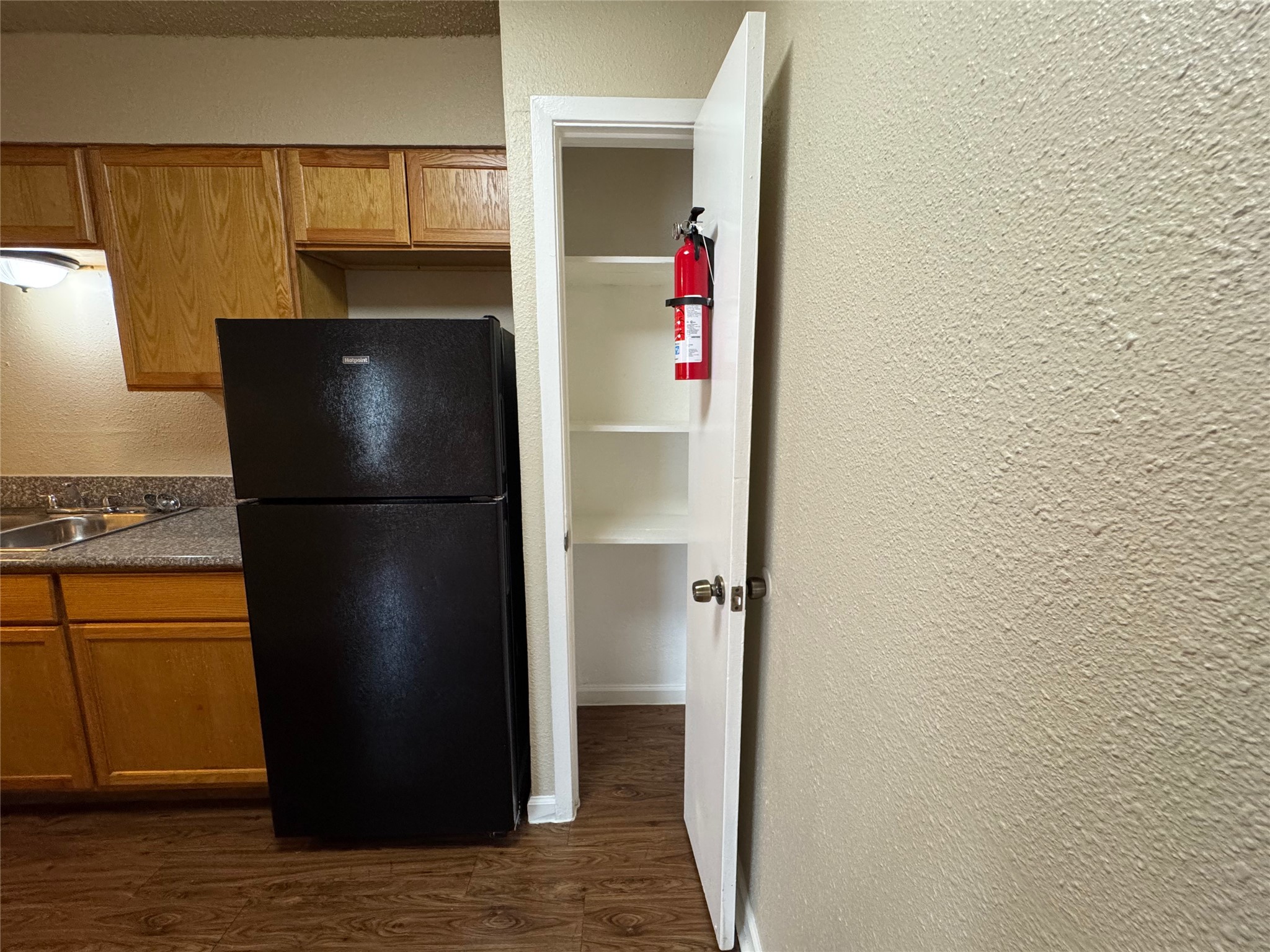 4904 West Wind Trail, Unit 102 Austin, TX 78745 - Photo 6 of 23 a kitchen with a refrigerator and a stove
