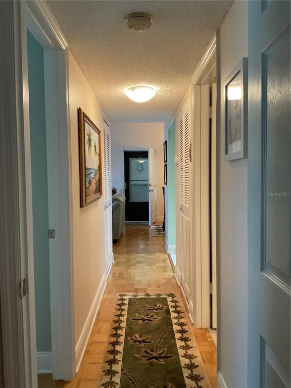 2655 Pine Ridge Way North, Unit D3 Palm Harbor, FL 34684 - Photo 14 of 31 a view of a hallway with wooden floor and staircase