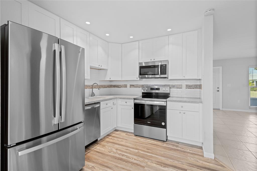 3801 42nd Street West Bradenton, FL 34205 - Photo 12 of 34 a kitchen with stainless steel appliances white cabinets and a refrigerator