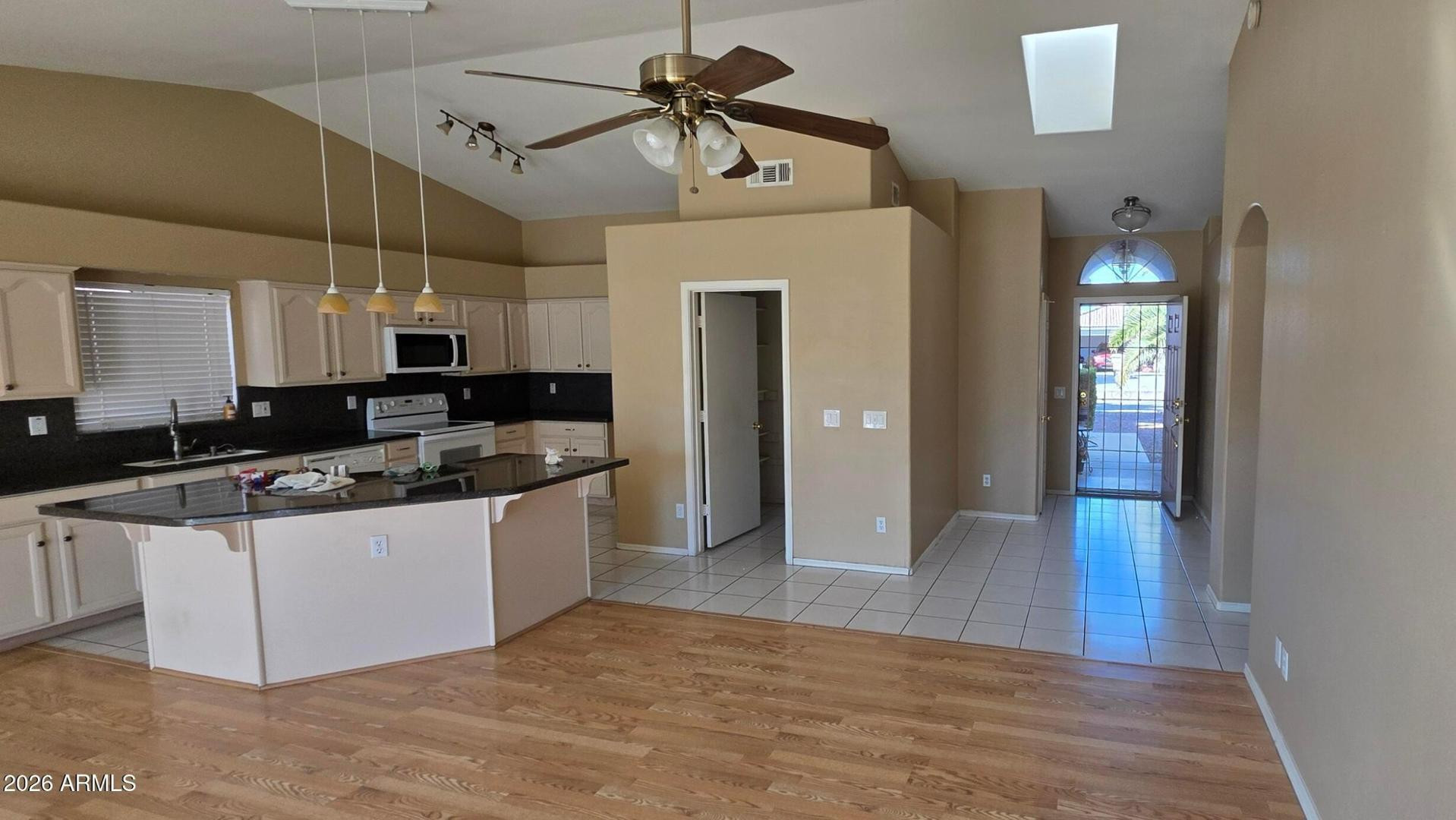a kitchen with stainless steel appliances granite countertop a sink and cabinets